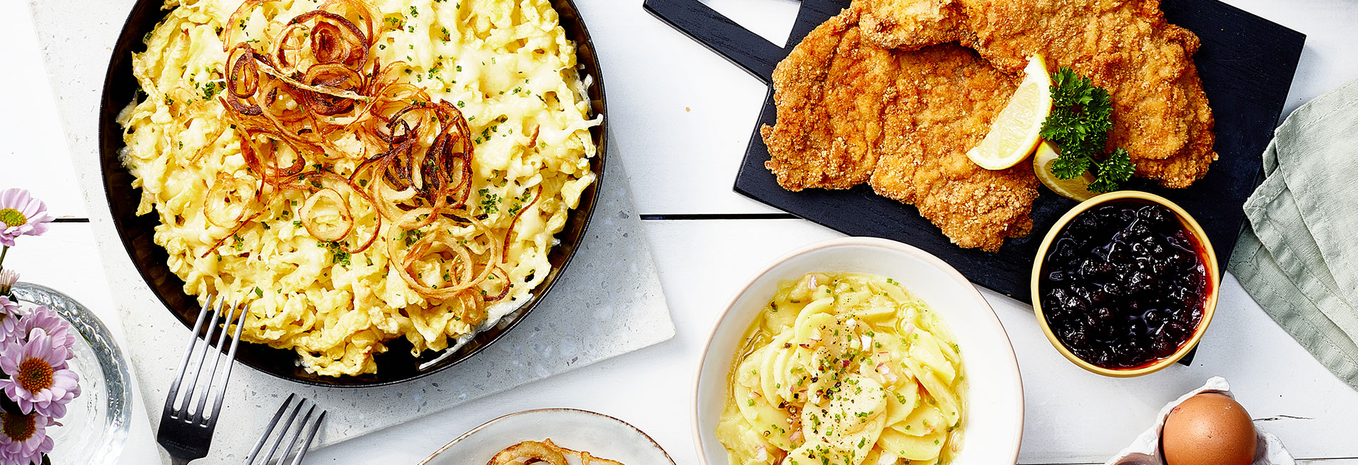 plates and cutlery are laid out on a rustic wooden table
