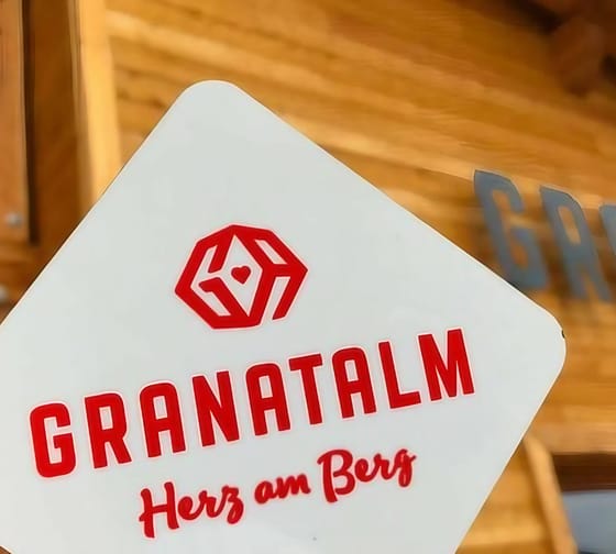 The image shows the Granatalm on the Penken with the logo in red lettering in the foreground.