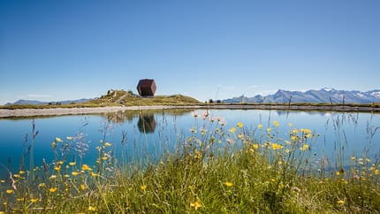 The image shows the Granatalm at Penkenjoch with a reservoir lake in the foreground.