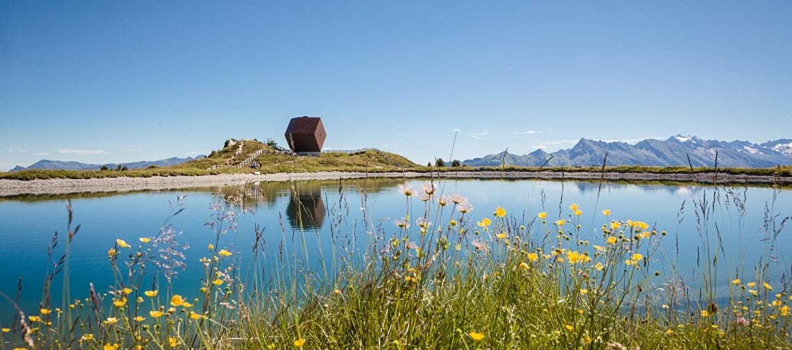 The image shows the Granatalm at Penkenjoch with a reservoir lake in the foreground.