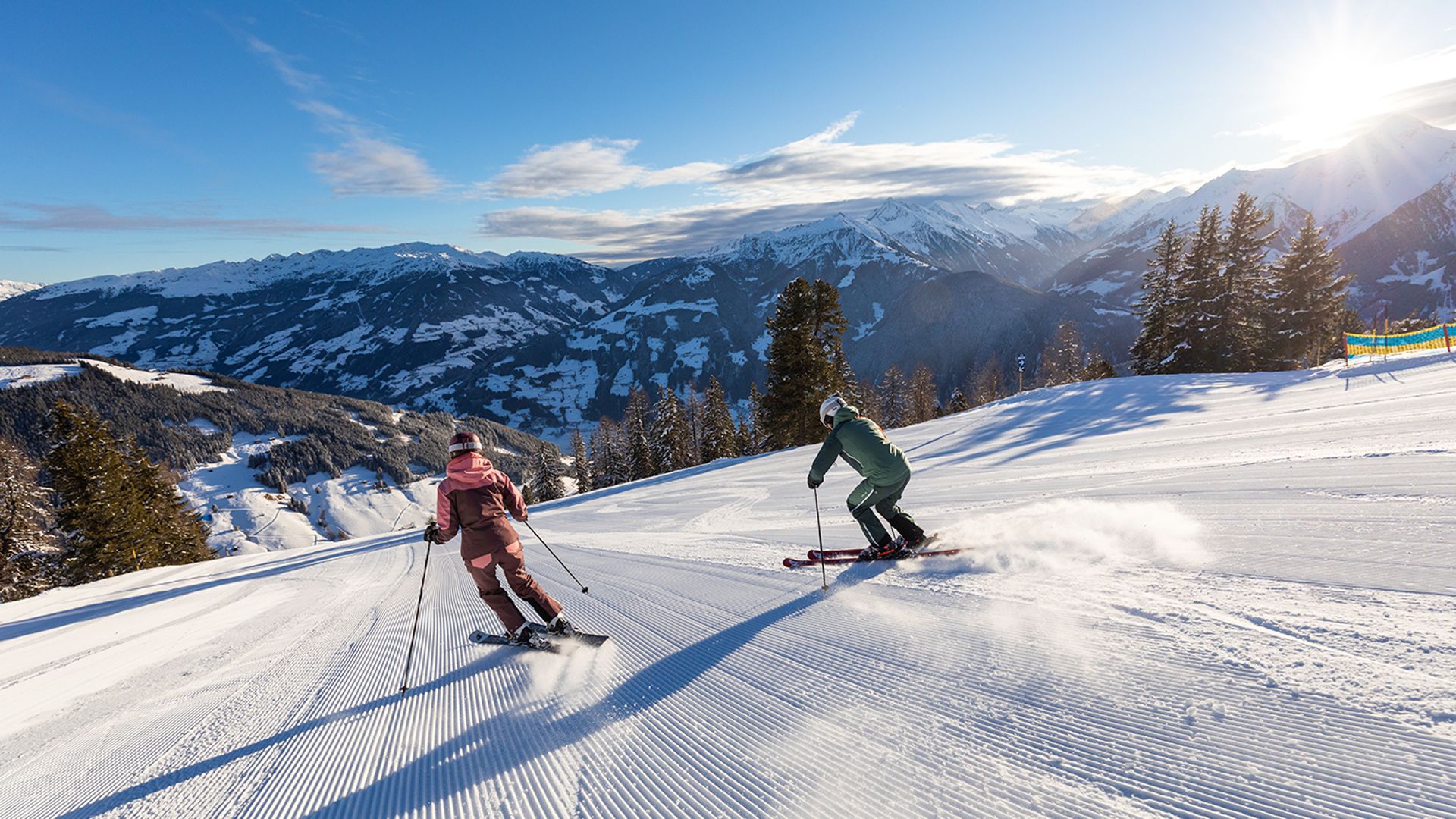Two skiers ski quickly down the "Black Attack" slope in the Mayrhofen mountains