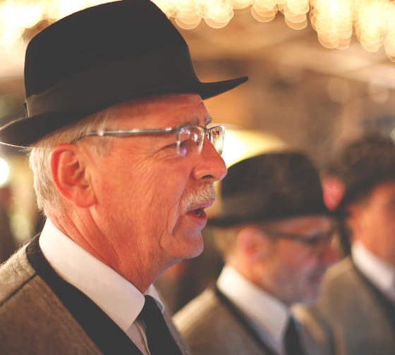 The picture shows the members of the Men’s Choir Association of Mayrhofen singing in their traditional costumes.