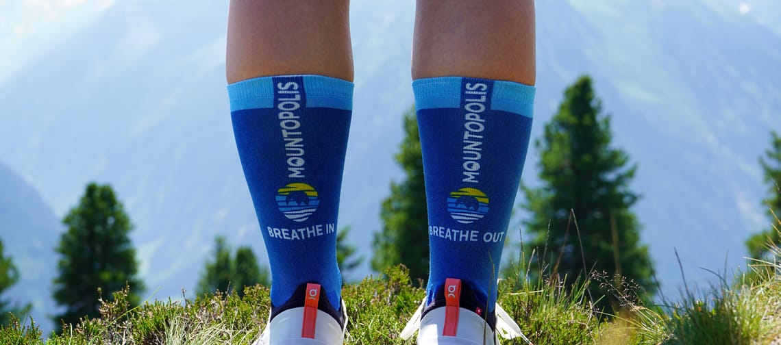 Mountopolis hiking socks of the Mayrhofner Bergbahnen with mountains in the background