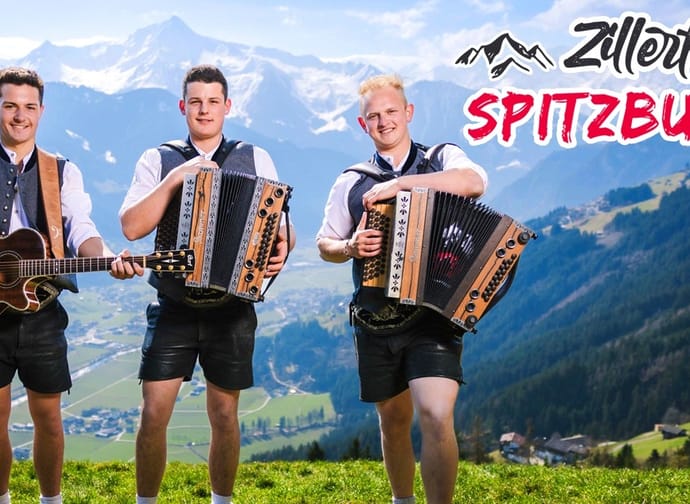 Three young men in traditional attire with guitar and accordion, mountain background, titled Zillertaler Spitzbuam