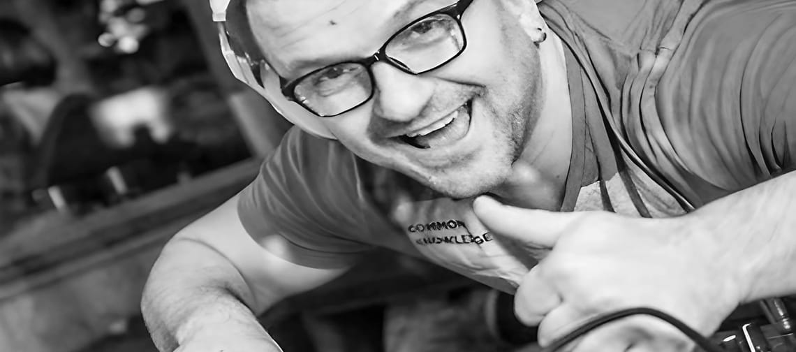 The picture shows a black-and-white photo of DJ Saja.