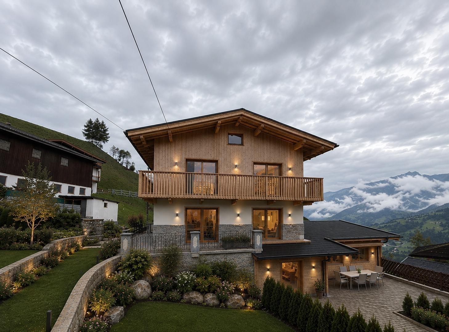 A two-story house with a wooden facade, balcony, and garden in the mountains under cloudy skies.