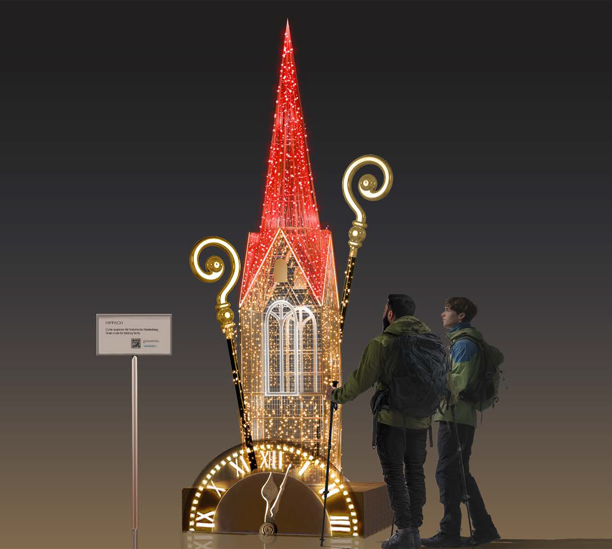 Beleuchtete Kirchturm-Installation bei Nacht in Hippach, Tirol: spitzer roter Turm mit goldenen Lichtornamenten auf rundem Sockel; zwei Personen mit Rucksäcken betrachten die Lichtskulptur vor dunklem Himmel.