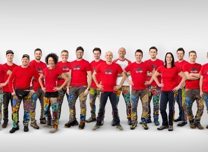 The Stocky Air team, wearing red T-shirts and black or brown pants, against a white background.