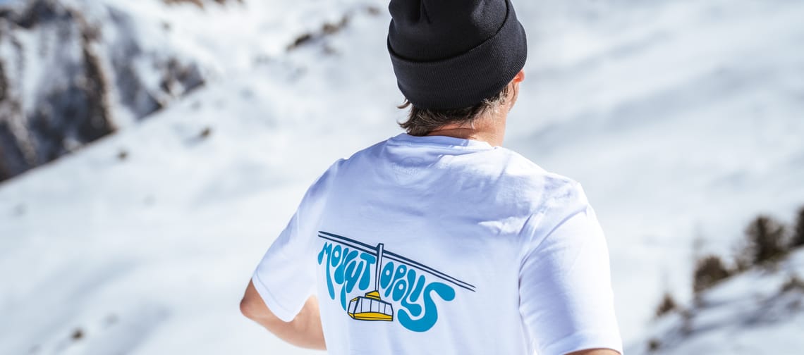 Man standing on the mountain wearing a Mountopolis shirt