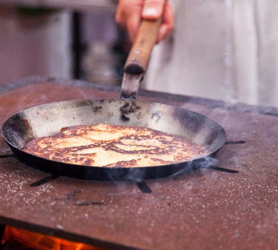 The image shows “Melchermuas” in a pan on the stove, a typical Zillertal specialty.