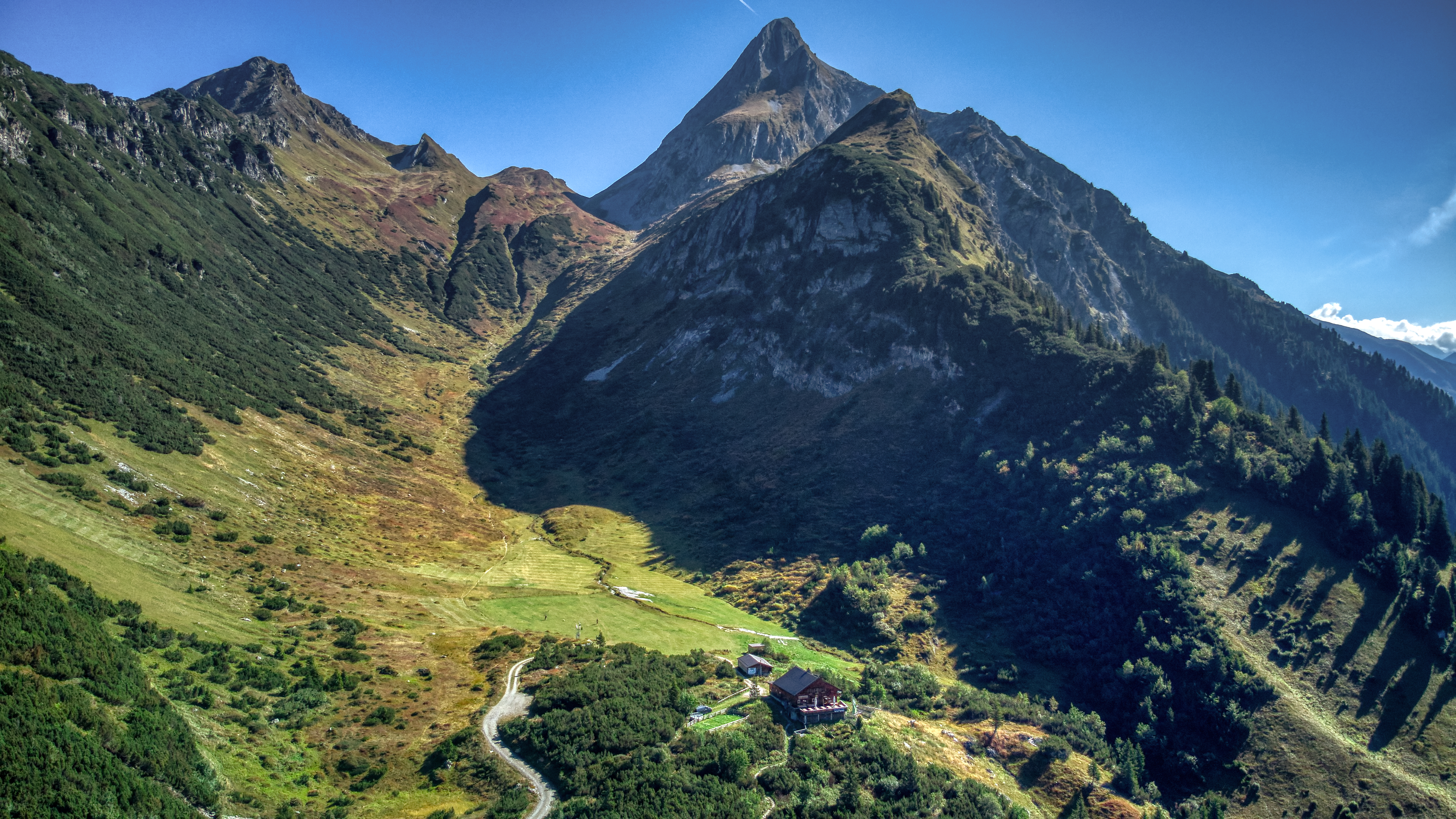 Green mountain landscape in Brandberg in the Zillertal valley, showing the mountain called Brandberger Kolm, which rises steeply into the sky.