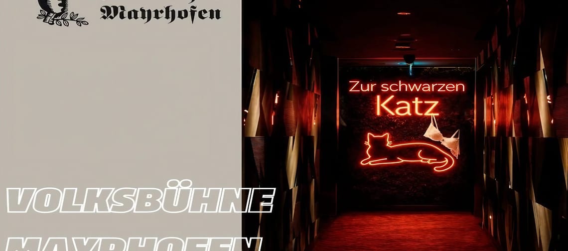 Dark corridor with red carpet and illuminated neon sign ‘Zur schwarzen Katz’ in the shape of a cat. On the left, logos and lettering ‘Volksbühne Mayrhofen’.