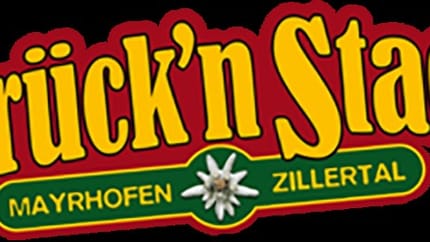 The logo of Brücken Stadl features a white background. The yellow lettering is framed in red, and below it, “Mayrhofen” is written and framed in green – a colorful and eye-catching design