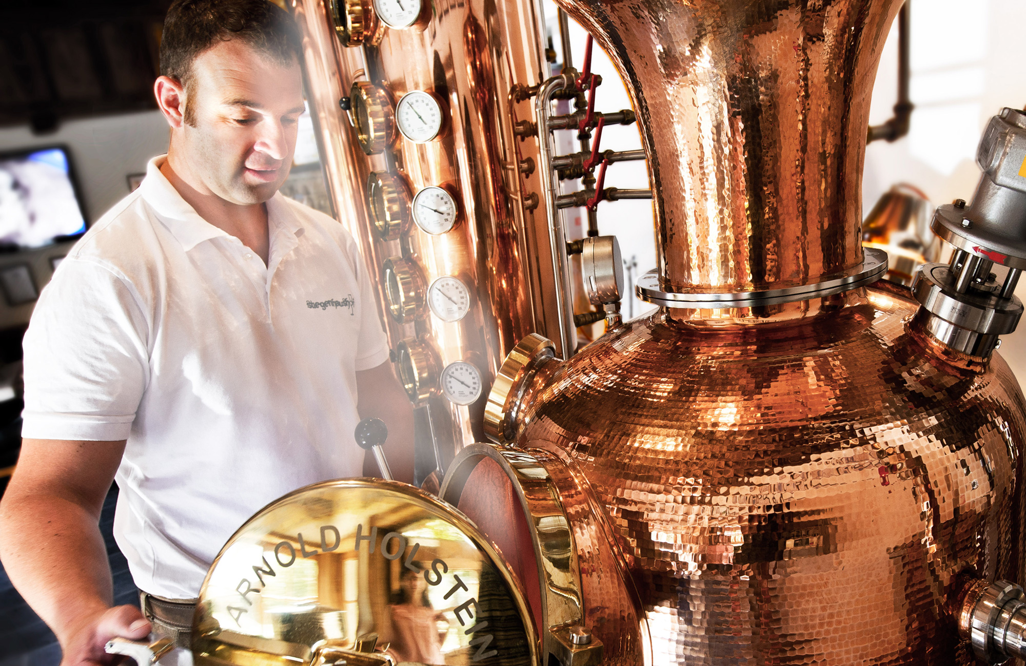 Master distiller at a shiny copper still in the Stiegenhaushof on the Schwendau Trail in Tyrol, Station 7 “Stiegenhaushof”.