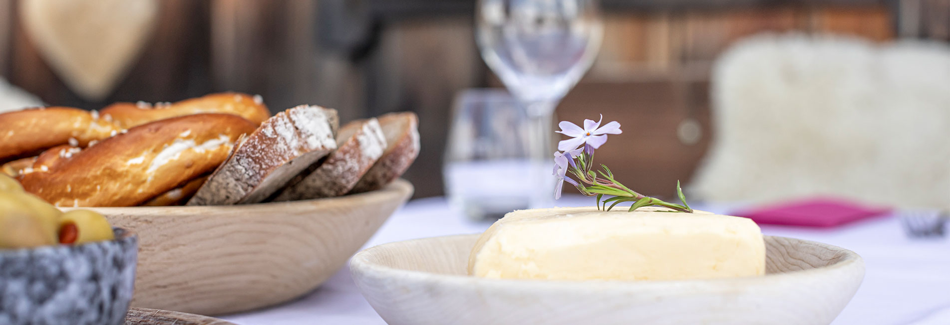 A richly laid table with berries, fruit and bread snack from a bird's eye view