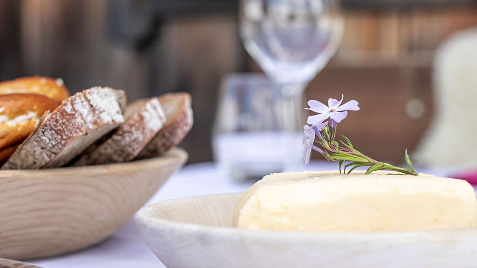 A richly laid table with berries, fruit and bread snack from a bird's eye view