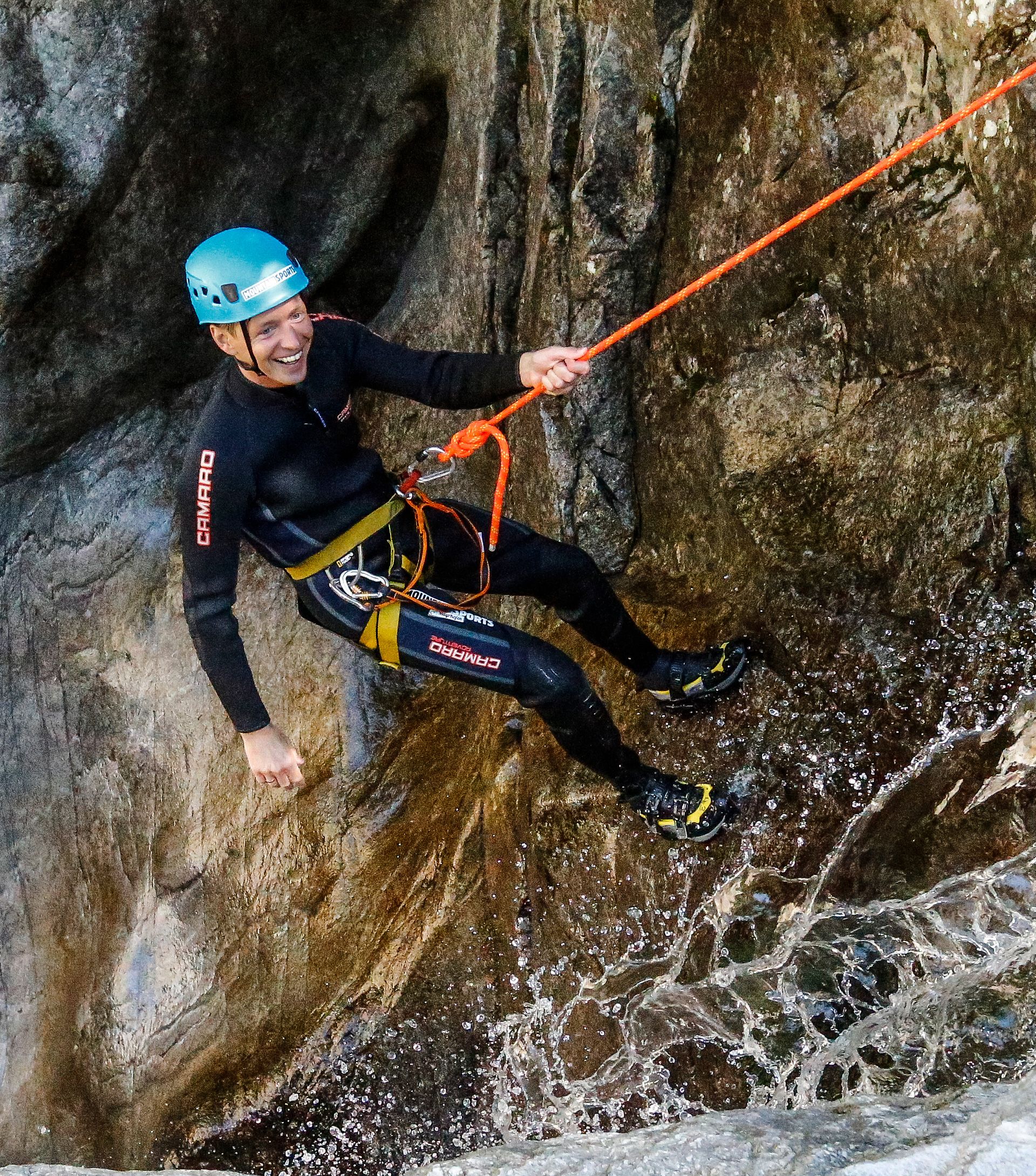 Frau mit Helm und Schwimmweste beim Tubing-Abenteuer auf einem Wildbach bei Mayrhofen-Hippach im Zillertal.