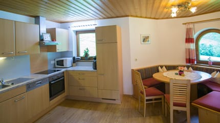 feratel-Apartment Bergblick - Große Wohnküche mit gemütlicher Sitzecke im Erker
