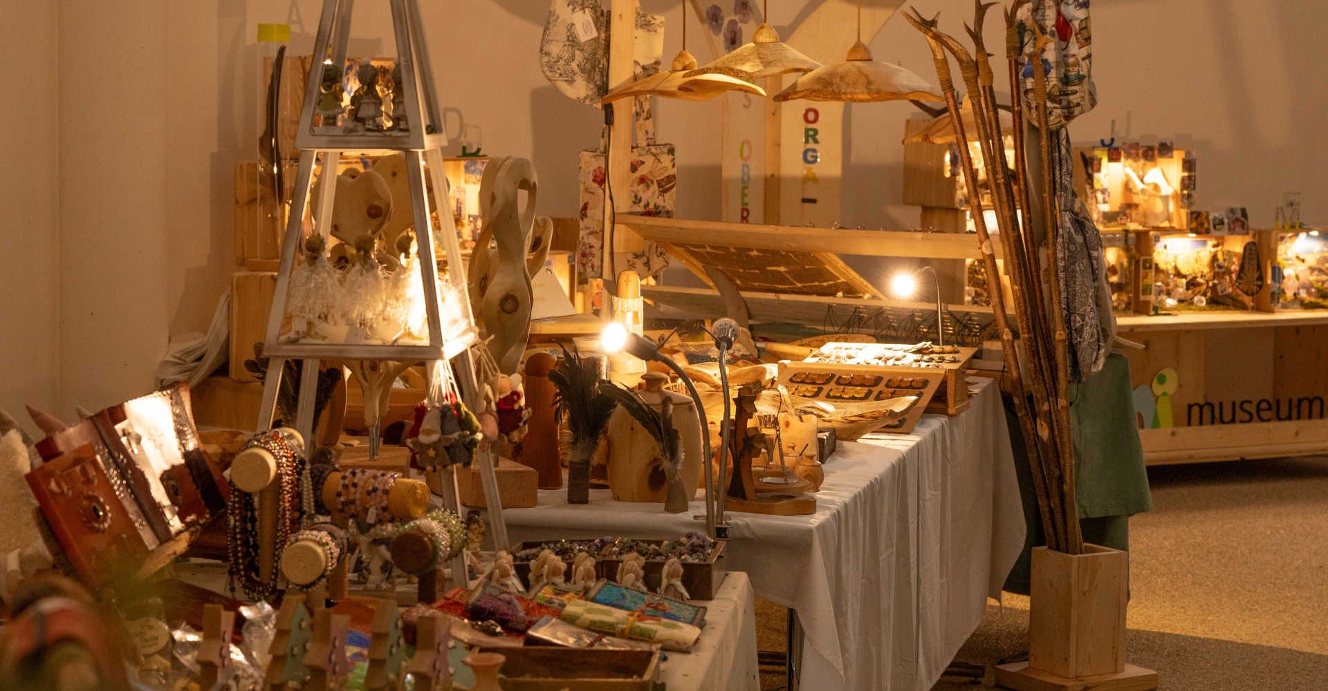 Craft market at the BIOS Bergadvent Mallnitz featuring regional products, festive decorations, and atmospheric lighting.
