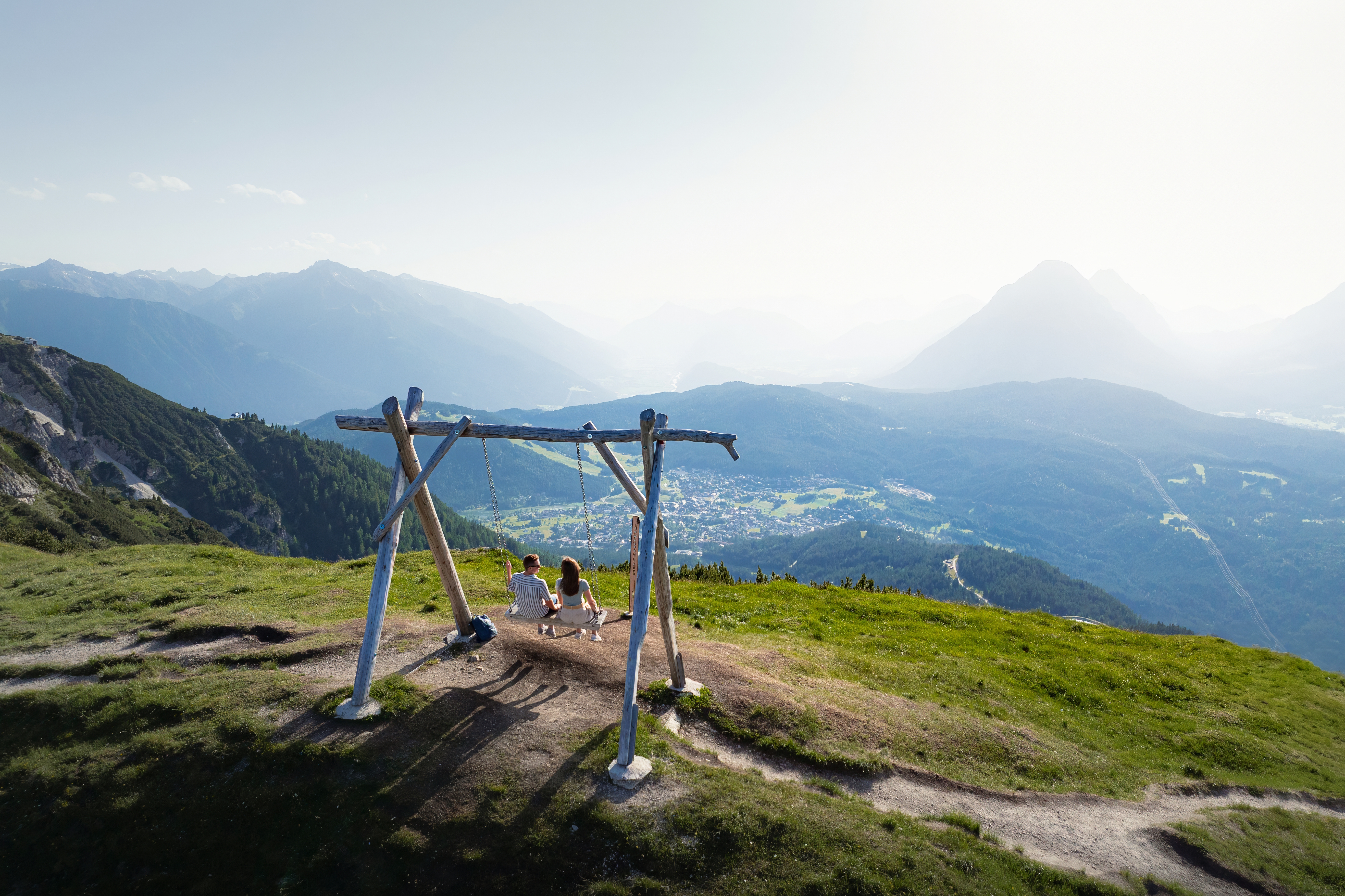 Swing on Seefelder Joch in summer_drone shot_view of Seefeld and Hohe Munde