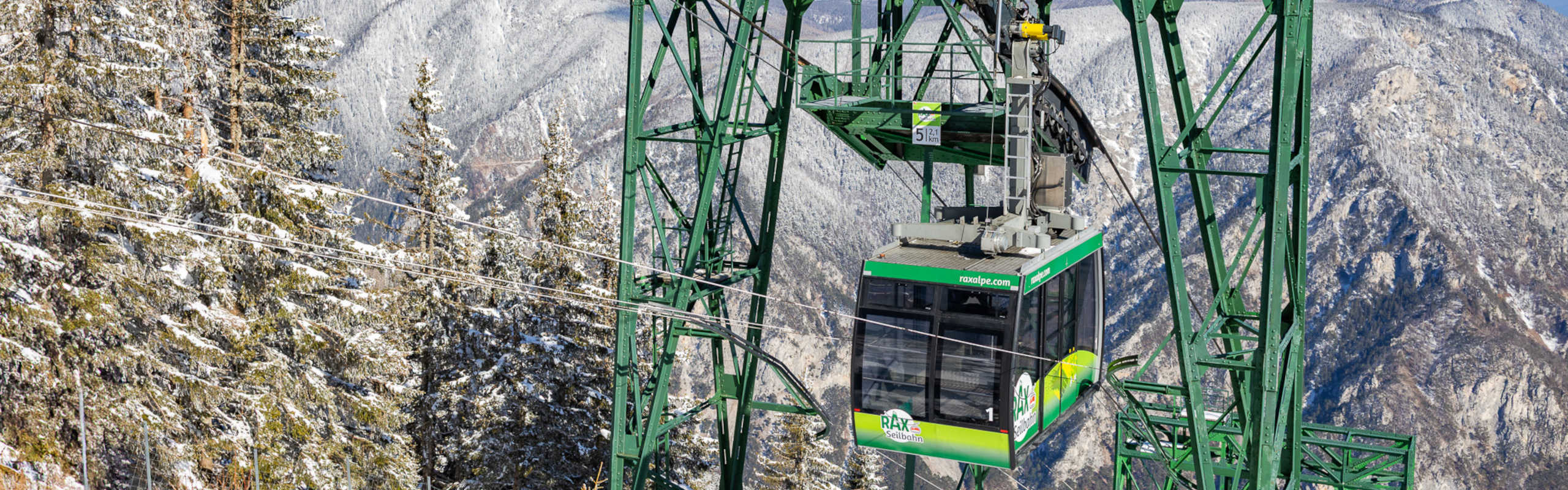 Rax-Seilbahn auf der Raxalpe in winterlicher Bergkulisse mit verschneiten Wäldern.