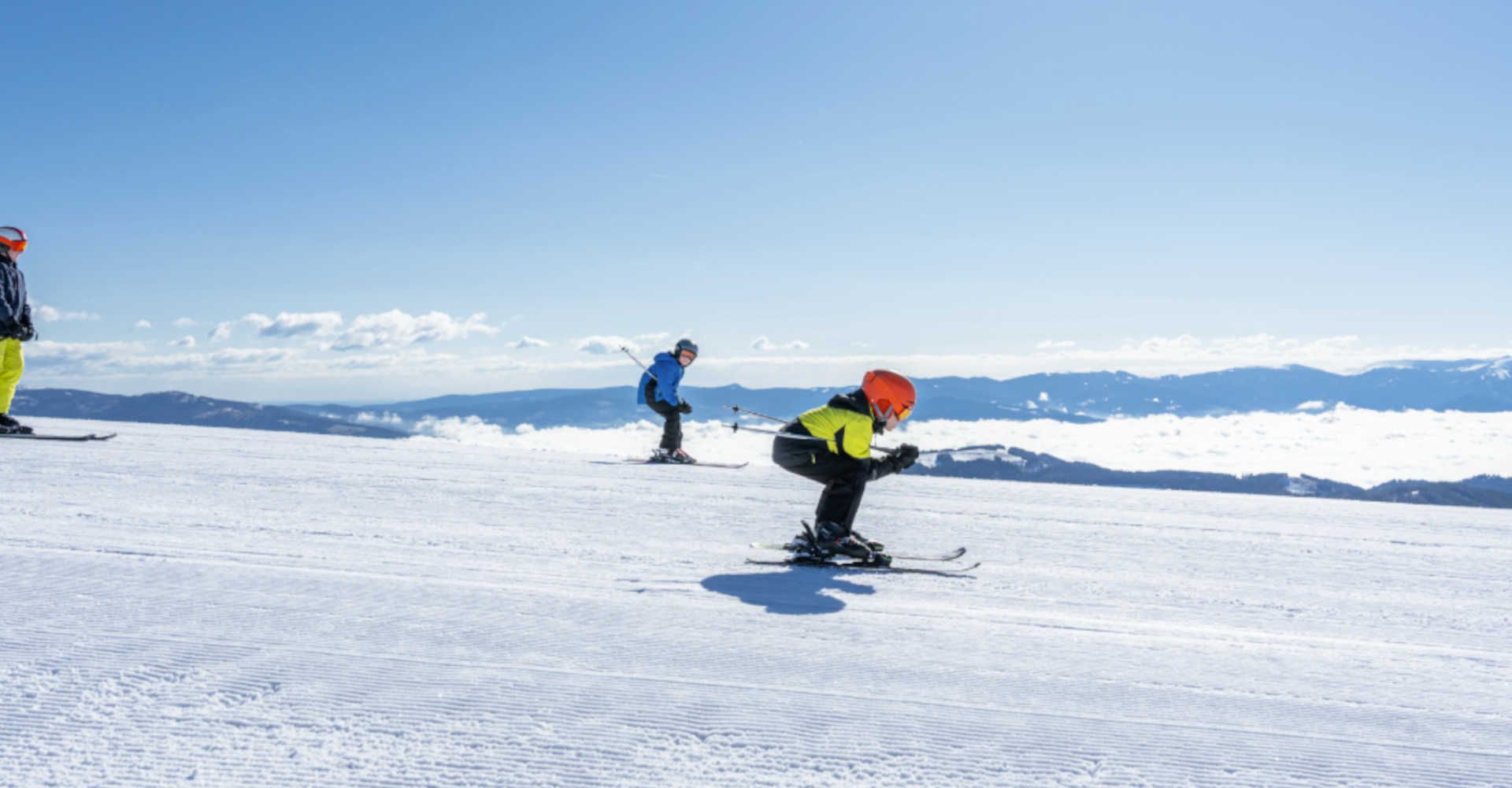 Skiing at Klippitztörl in Carinthia: Winter sports enthusiasts enjoy perfectly groomed slopes in the sunshine, surrounded by an impressive Alpine panorama.
