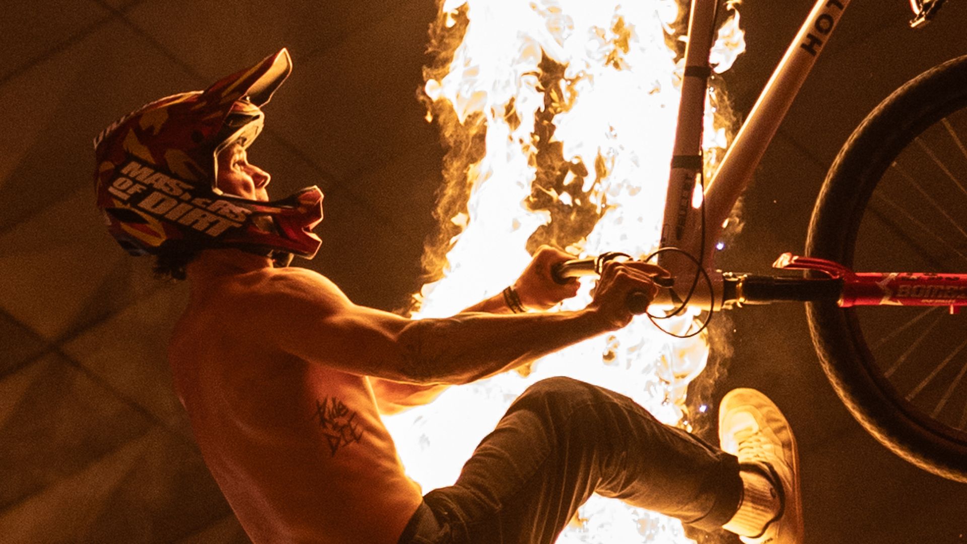 Motorcyclist with a fire background
