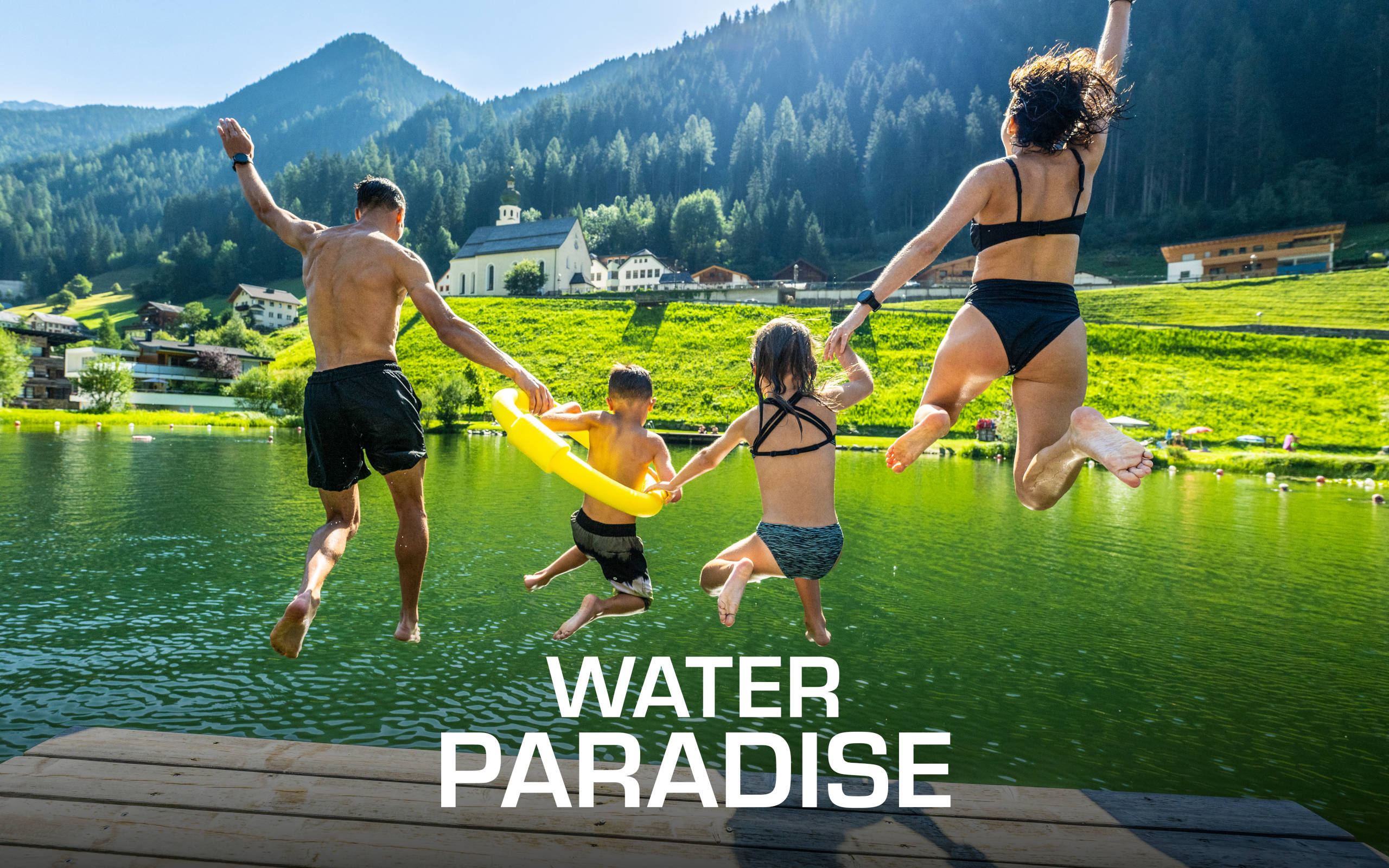 Family jumping into the lake