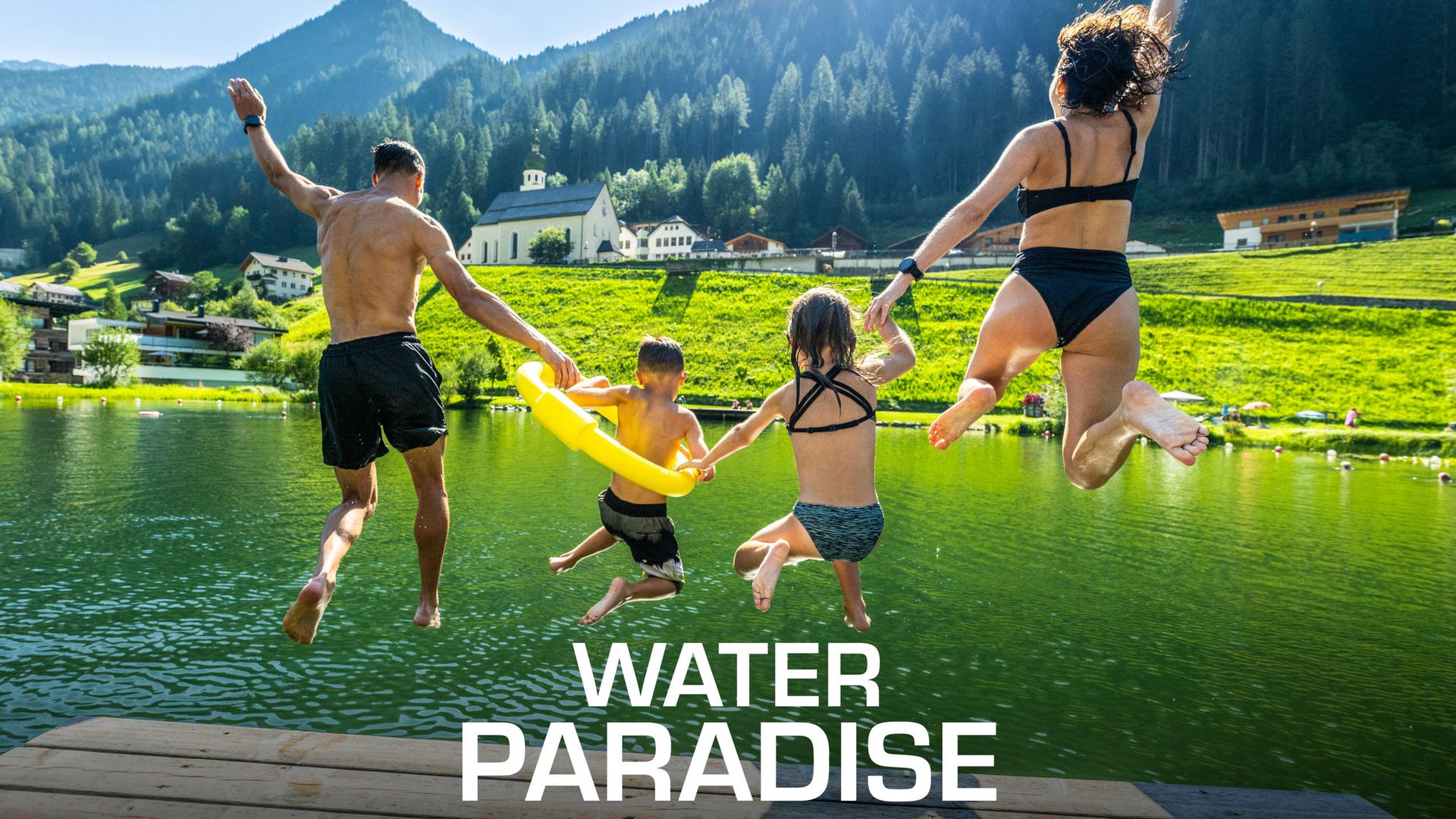 Family jumping into the lake