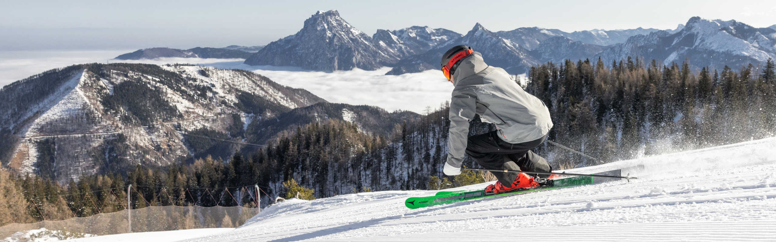 Skiing at Feuerkogel, surrounded by snow-capped mountains and an impressive Alpine panorama.