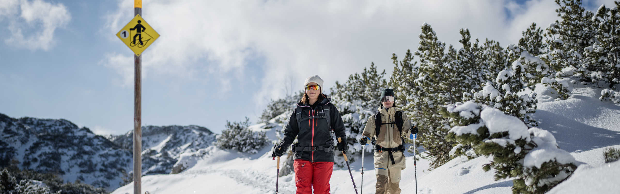 Snowshoeing on the Feuerkogel along a snow-covered trail in a wintry Alpine landscape.