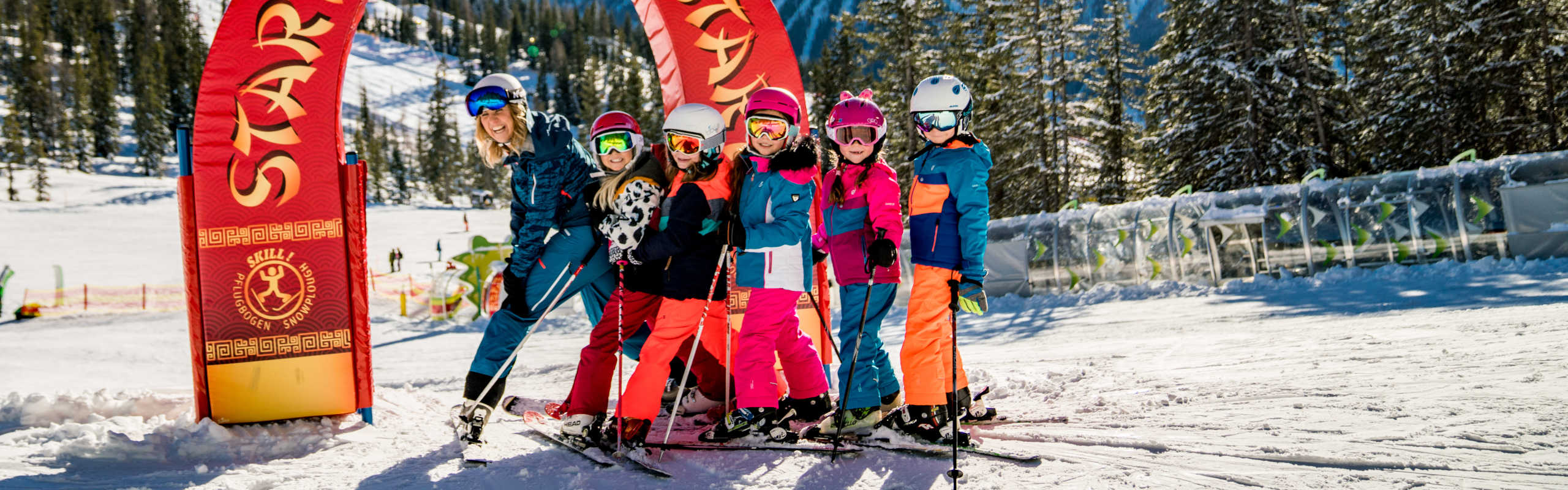 Children at Hopsiland on the Planai in Schladming, skiing and learning in the family-friendly winter adventure area.