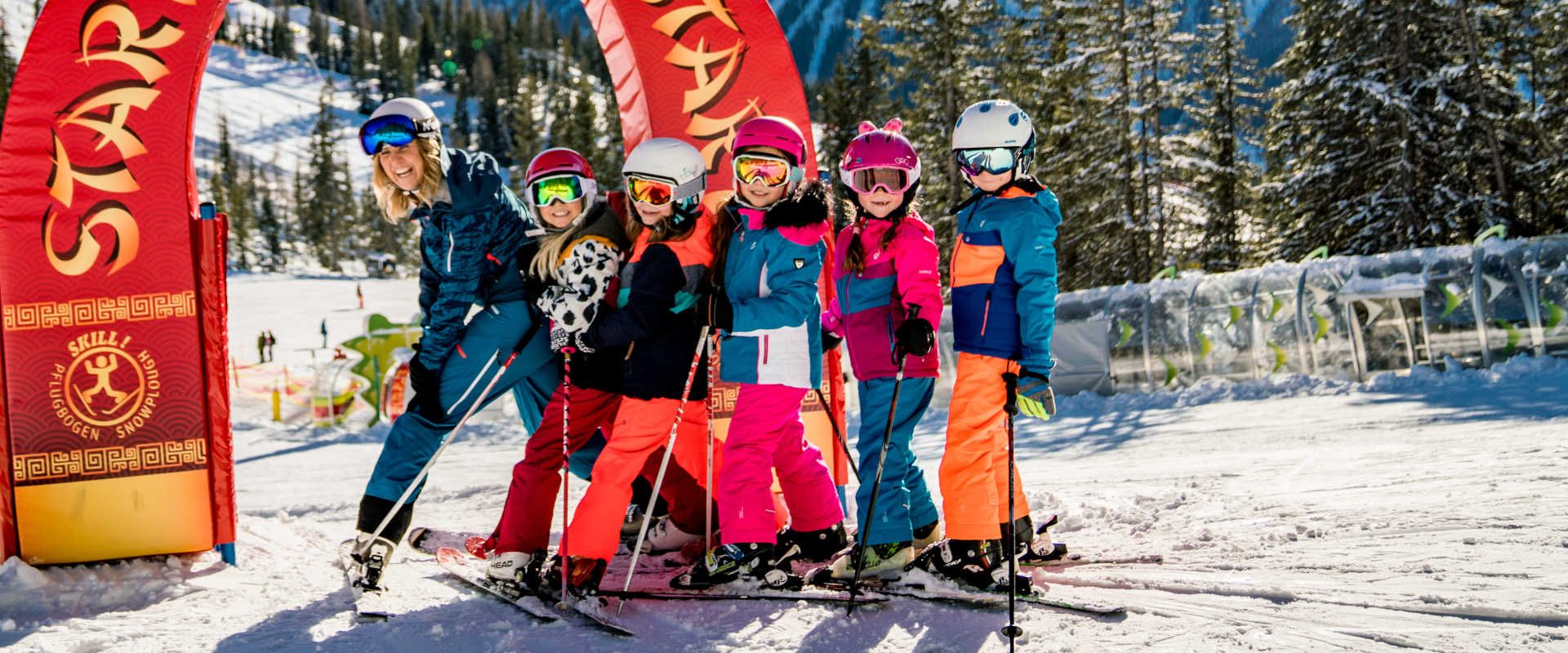 Children at Hopsiland on the Planai in Schladming, skiing and learning in the family-friendly winter adventure area.