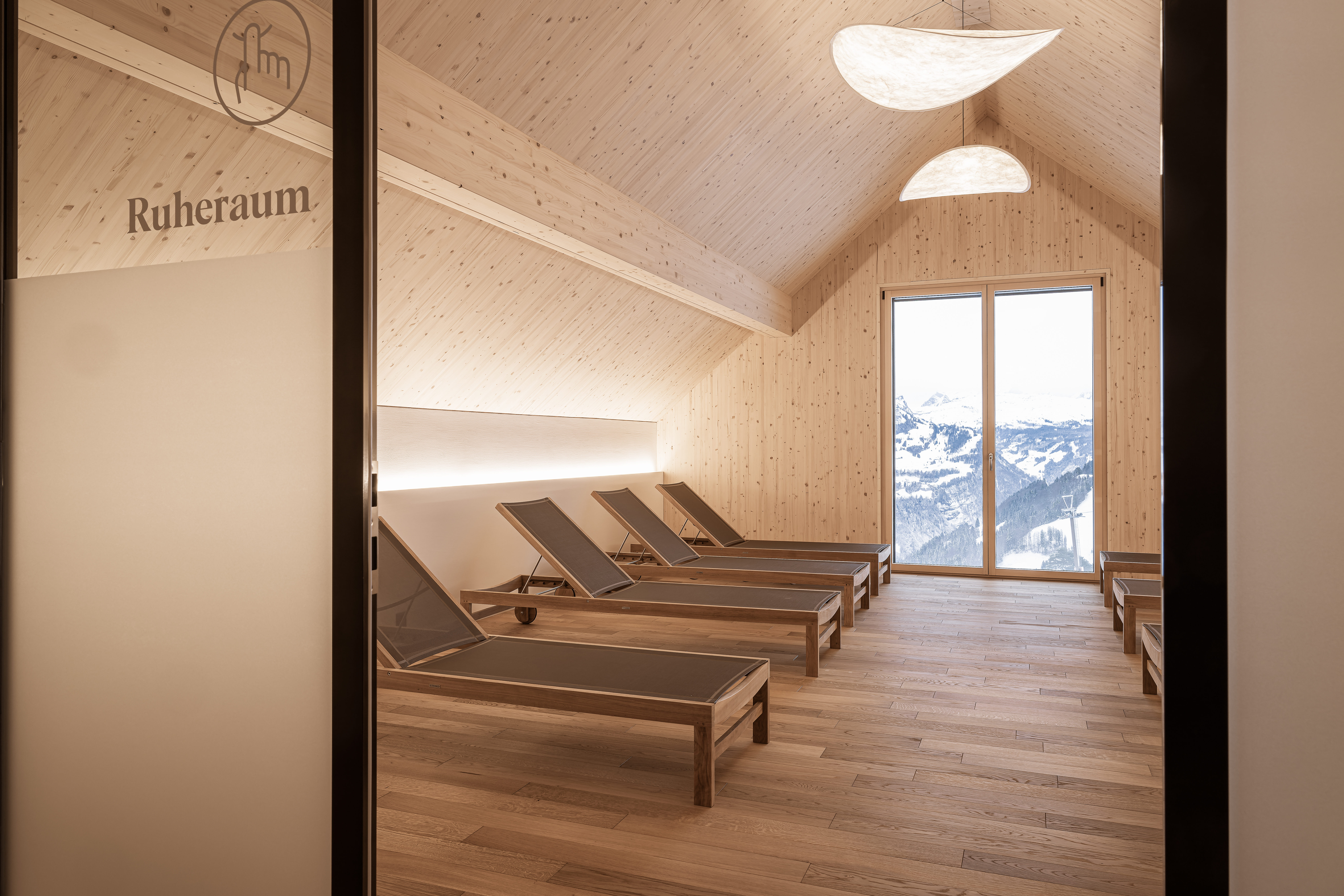 Ruheraum mit Liegen und warmem Licht in ruhiger Atmosphäre.