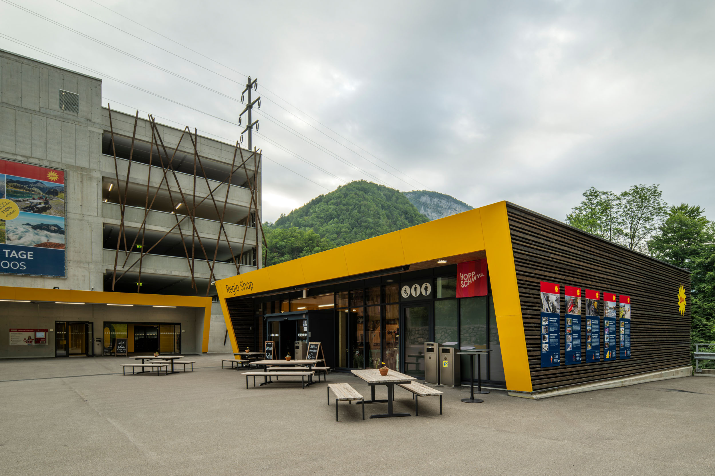 Regio shop at the valley station of the Schwyz–Stoos funicular with modern architecture and seating area.