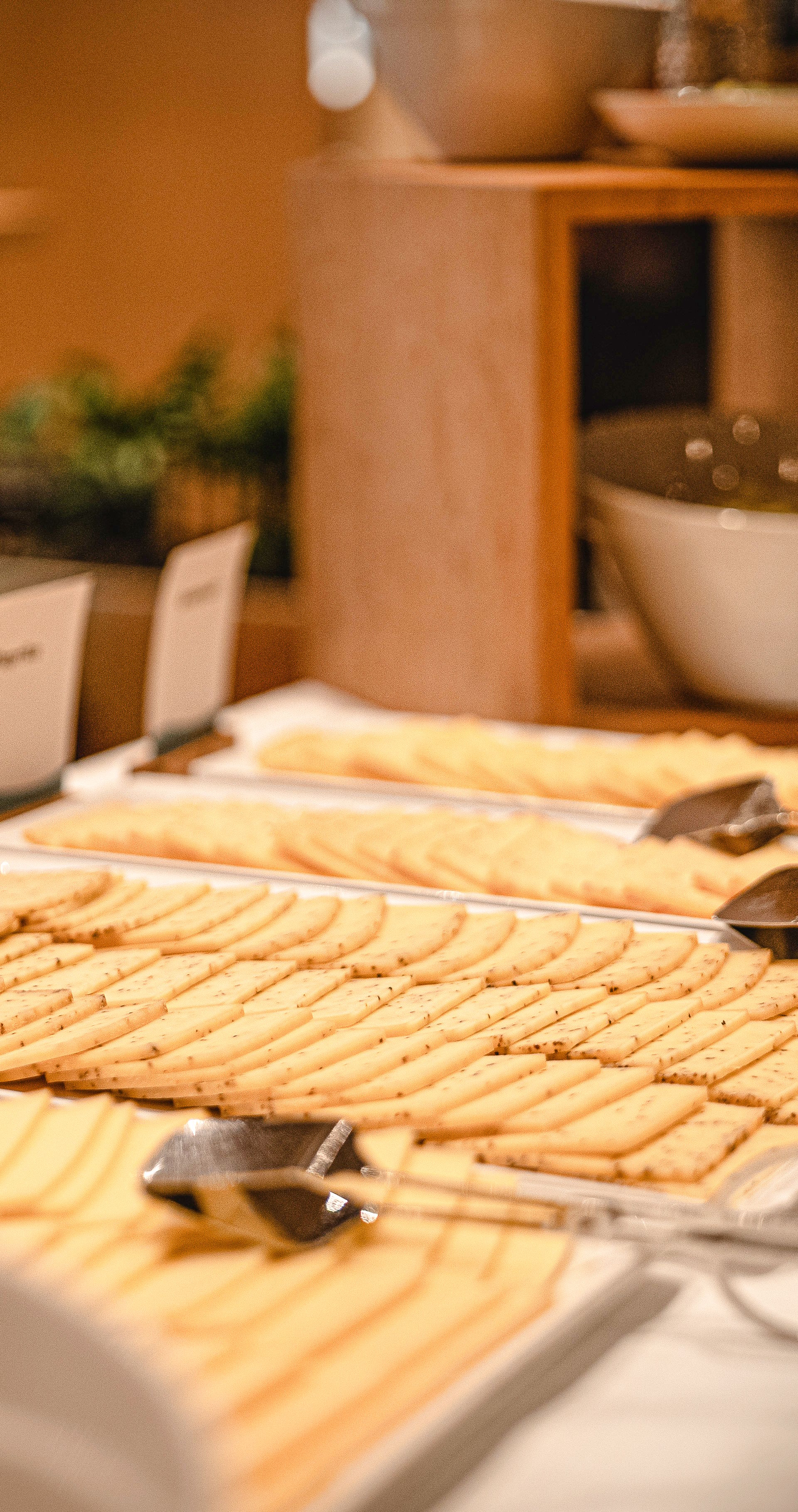 Buffet with cheese fondue, raclette ingredients and side dishes on board a ship.