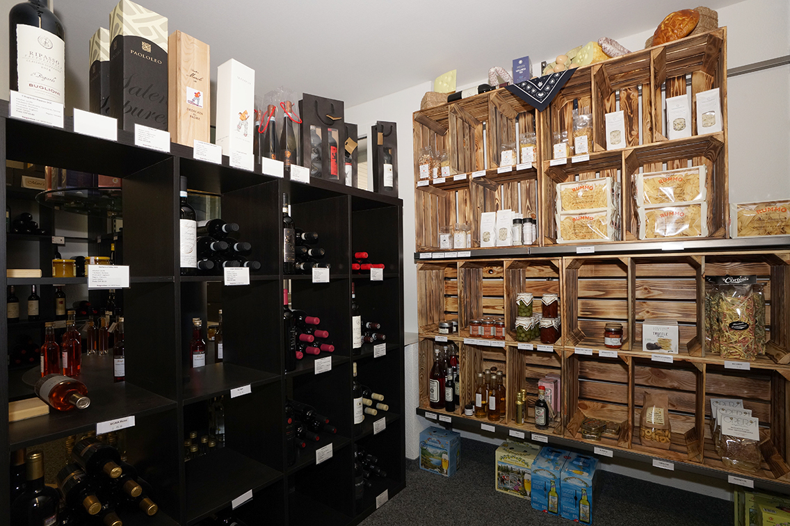 Retail area with shelves and beverage crates for shopping.