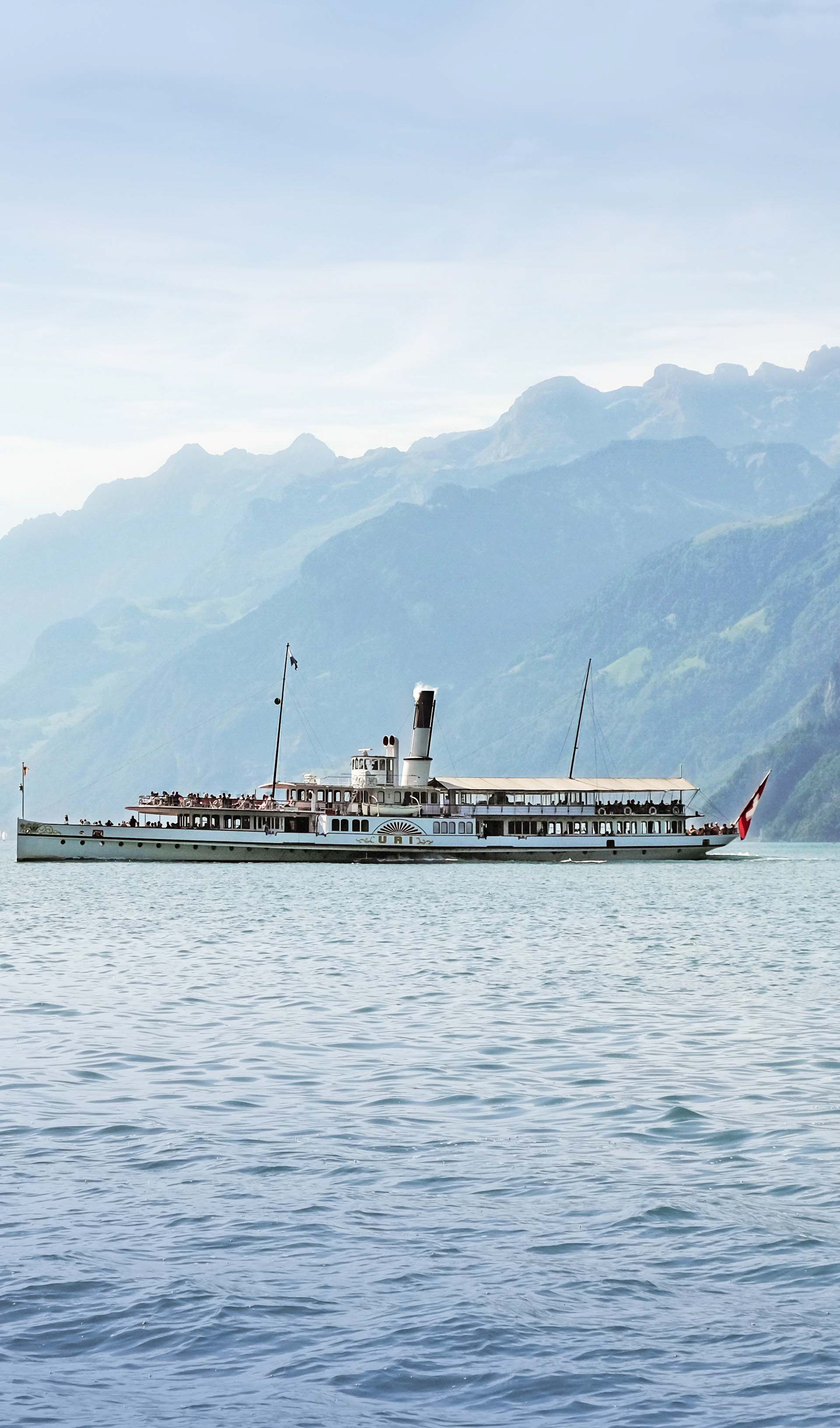 Historisches Dampfschiff auf dem Vierwaldstättersee während der grossen Seerundfahrt mit Bergpanorama.