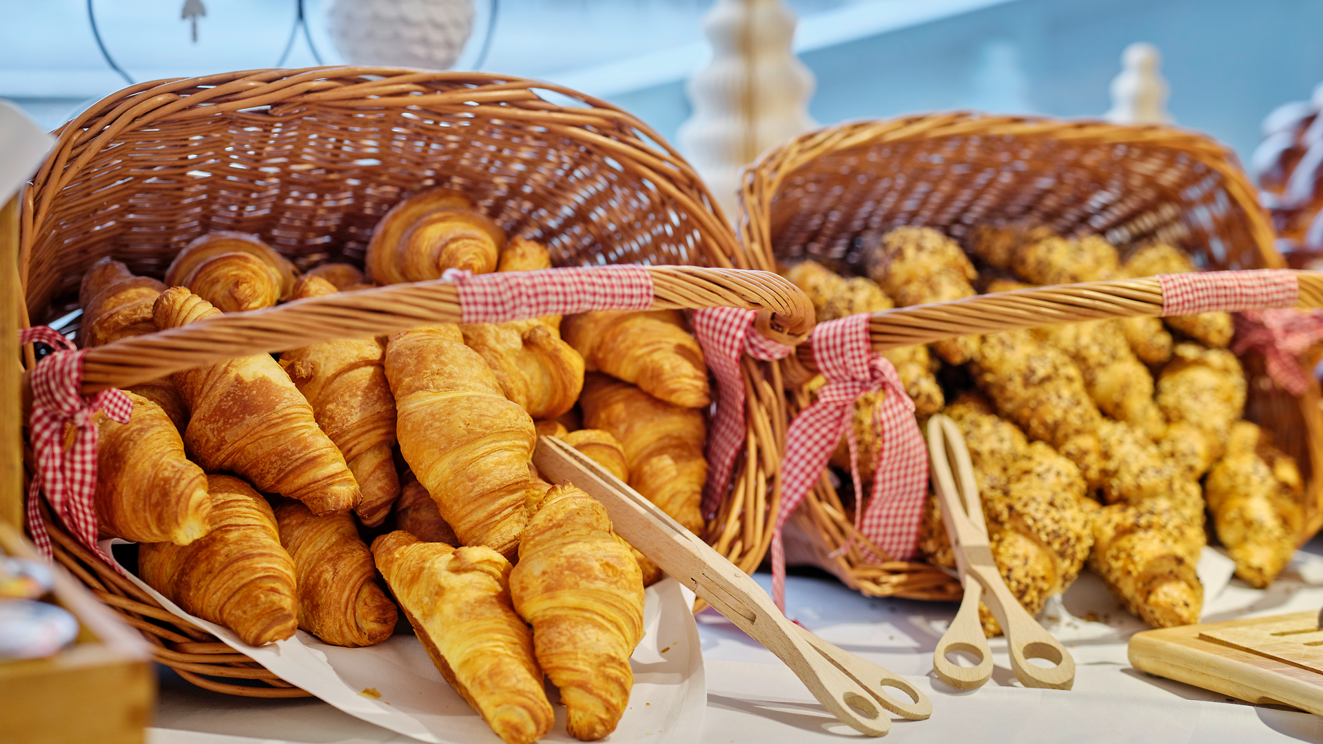 Fresh croissants and pastries in baskets on a breakfast buffet on board a ship.