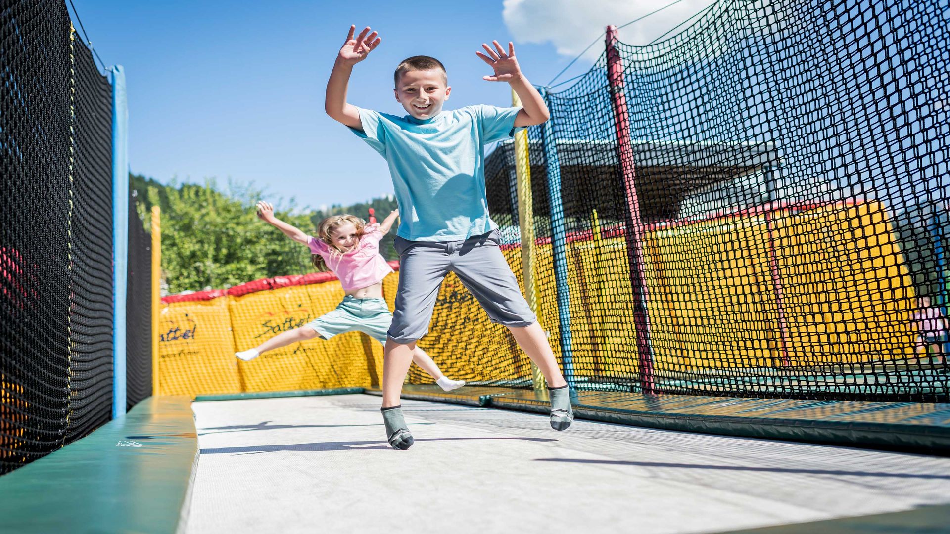 Hochstuckli - pure action. Two children bouncing happily on a bouncy castle.