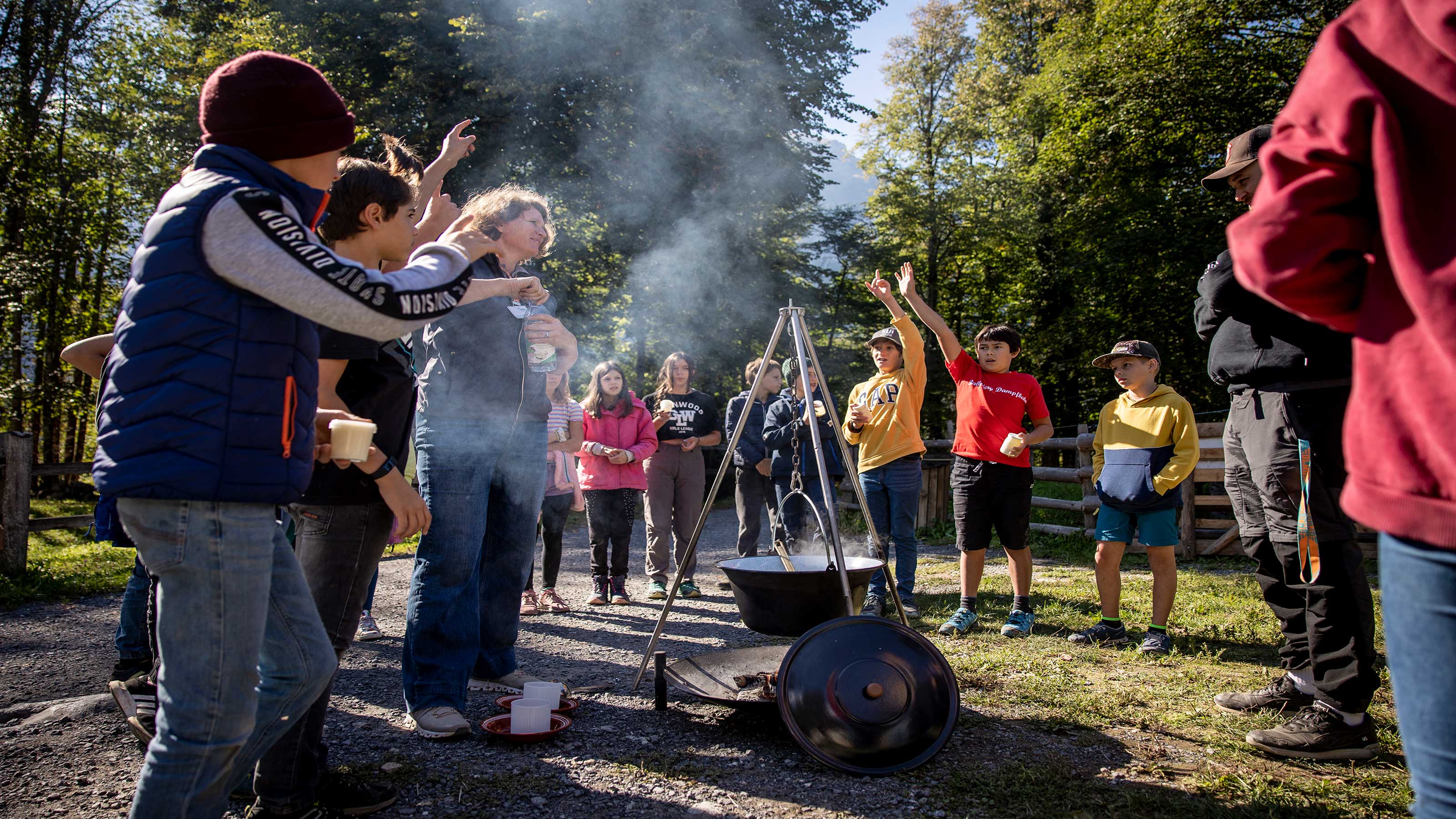 School class standing around a campfire.
