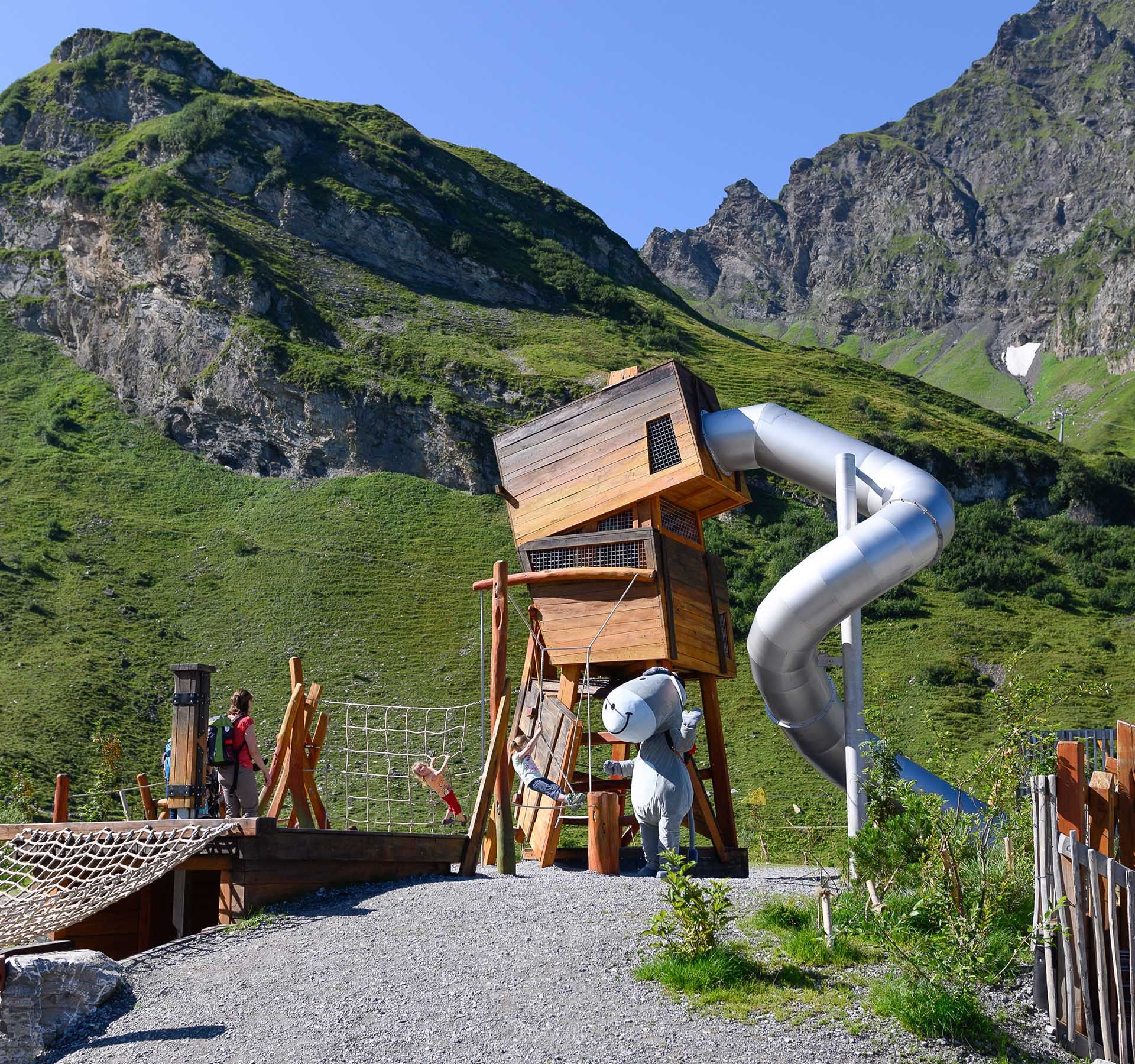 View of the Schmuggler playground on Engelberg-Trübsee with slide, climbing obstacles and much more. Plus a great mountain panorama.