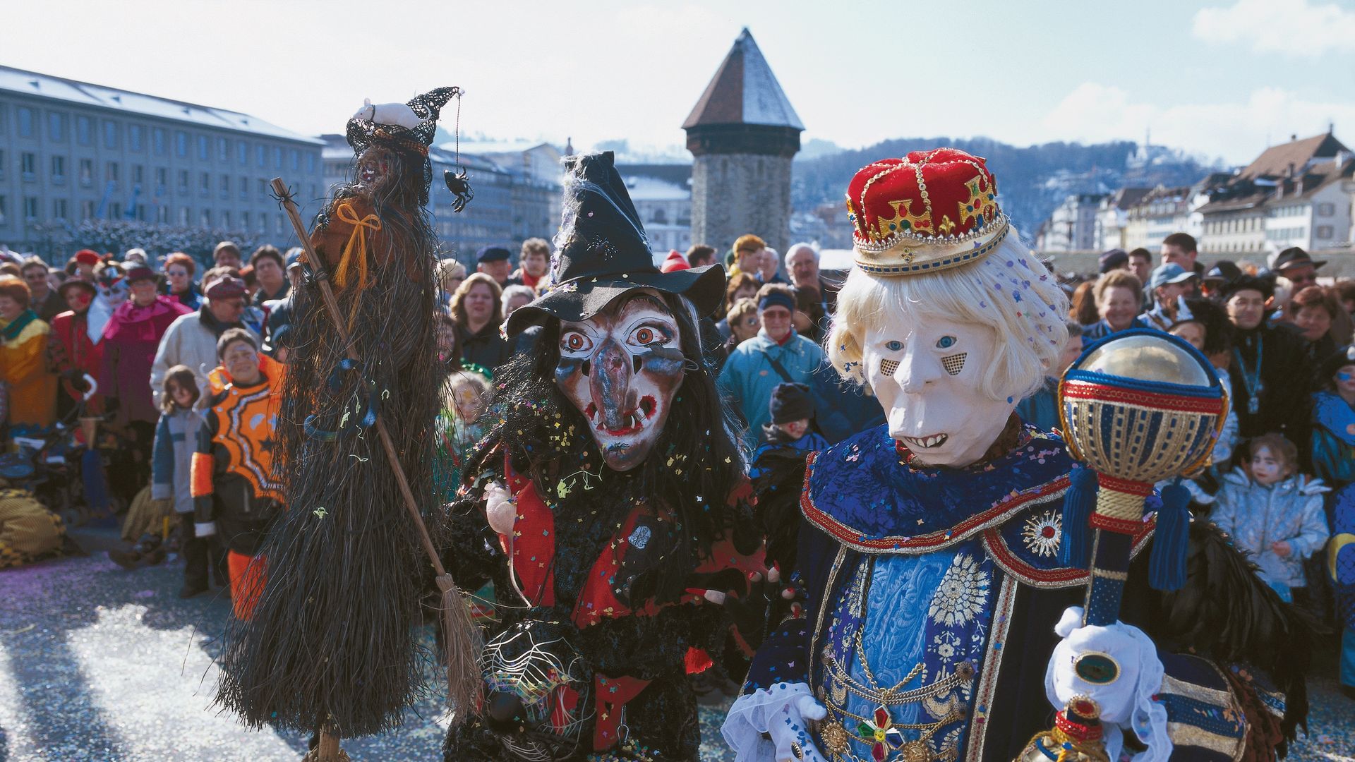 Friends walking through Lucerne train station on their way to the Lucerne Carnival.