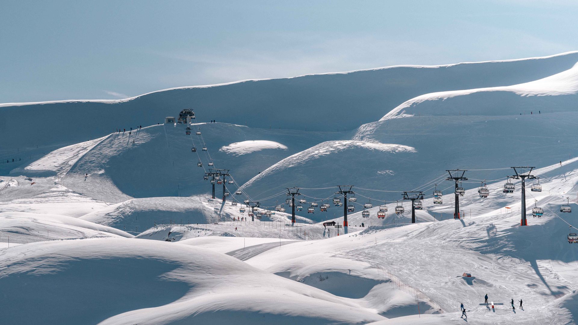 A pristine ski slope blanketed in fresh snow, inviting skiers to enjoy a day of winter sports and recreation.