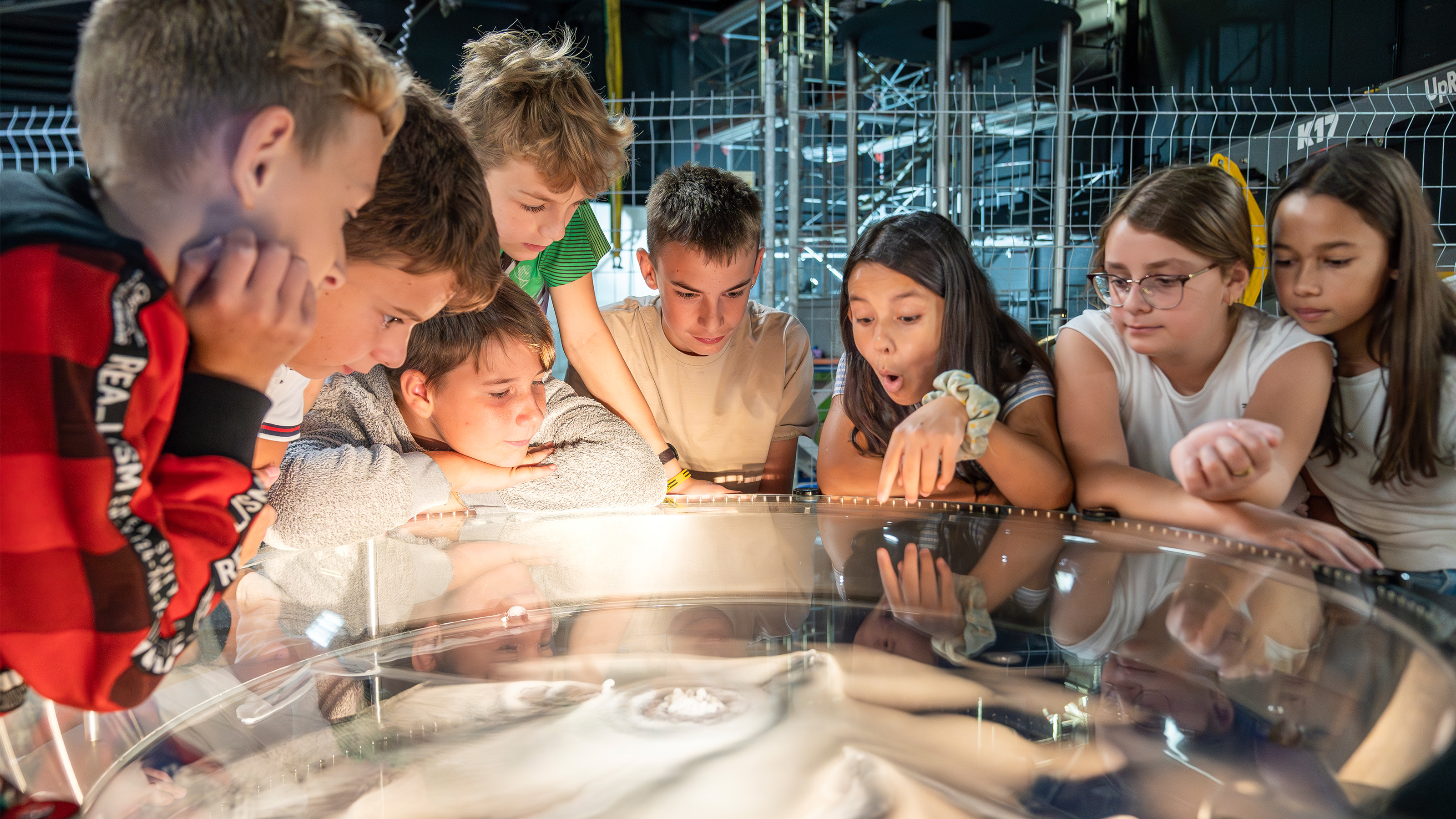 Pupils watch with fascination as an experiment with water vortexes is conducted in the indoor area of Technorama.