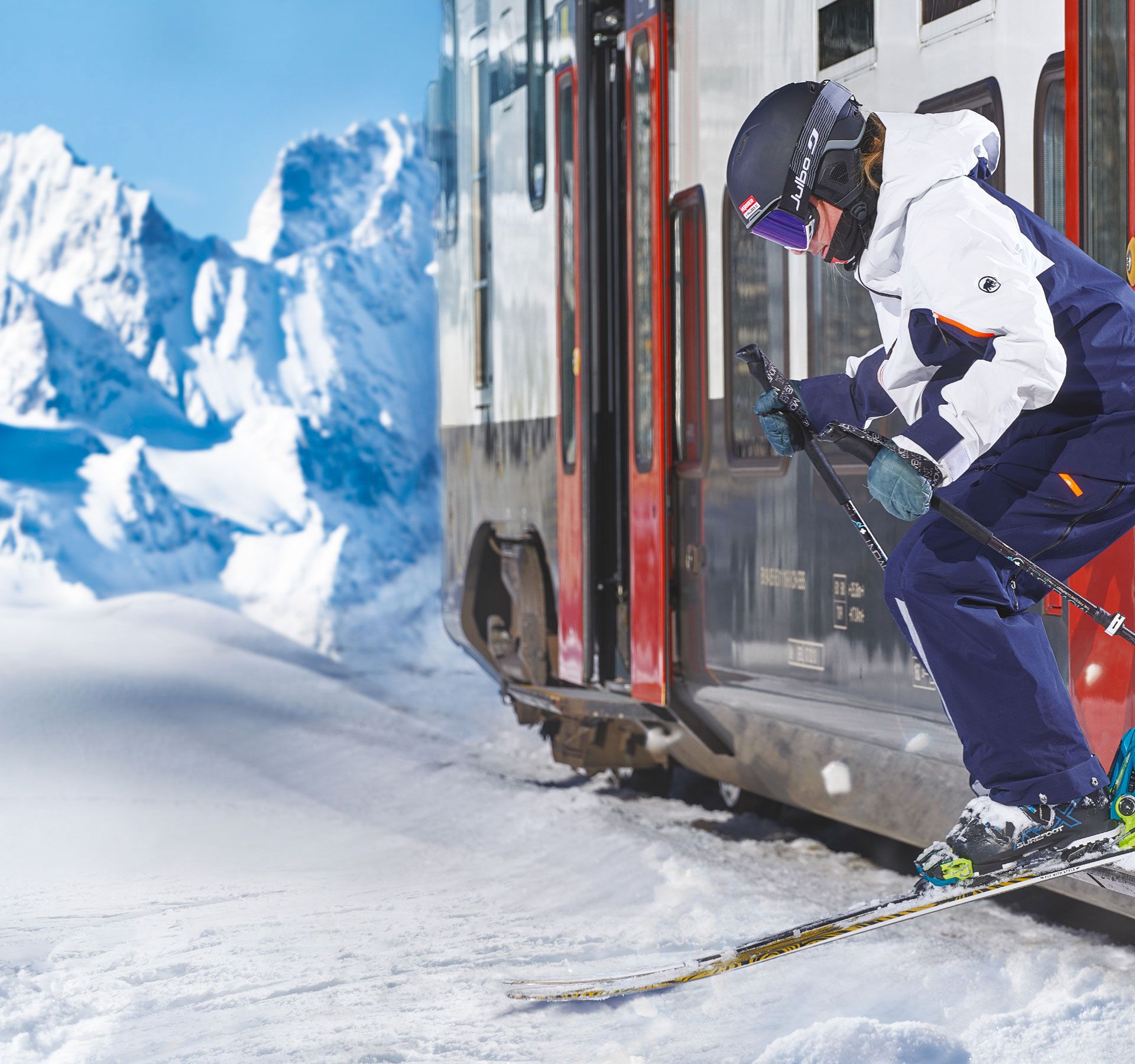 A person jumping off a train with their skis in the snow