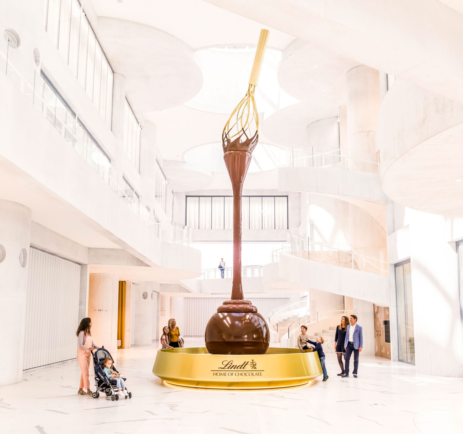 Large sculpture of a chocolate spoon with flowing chocolate in the bright, modern interior of the Lindt Home of Chocolate.