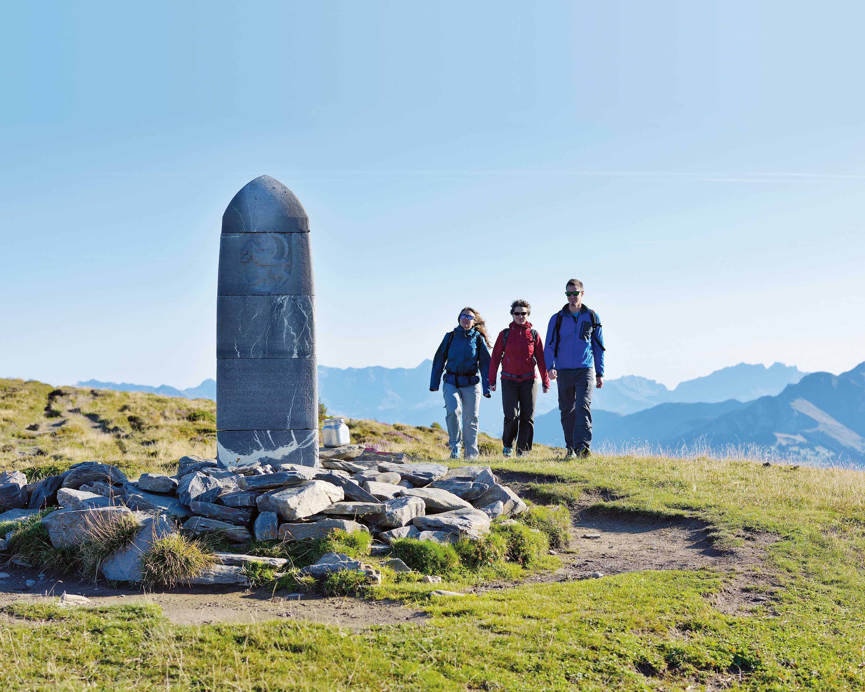 A hiking group approaches the Dreibündenstein above Chur at over 2000 metres.
