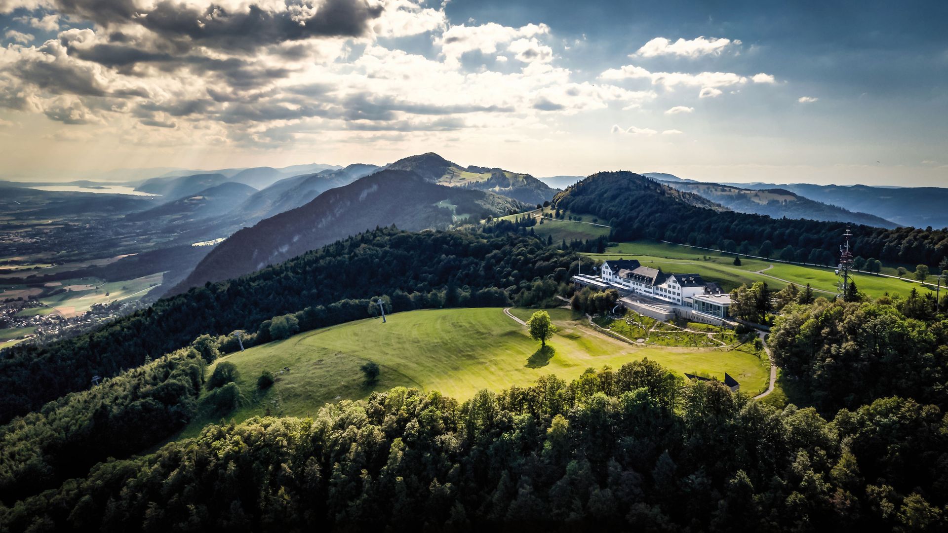 Vista aerea della stazione di montagna sul Weissenstein. Il sole filtra attraverso le nuvole e immerge il paesaggio in una luce mistica. 