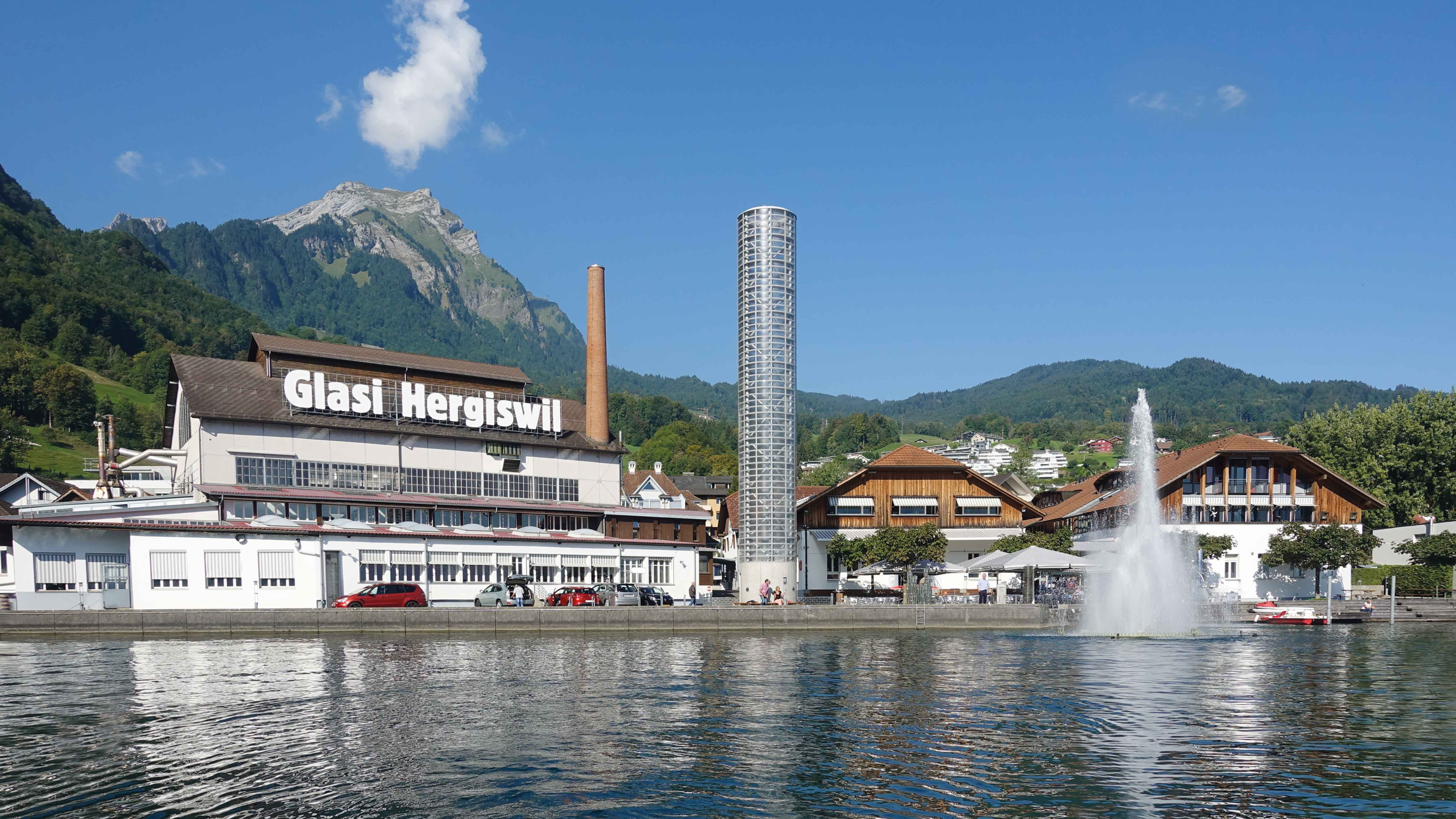  A large building stands majestically with a fountain gracefully flowing in front of it, creating a serene atmosphere.